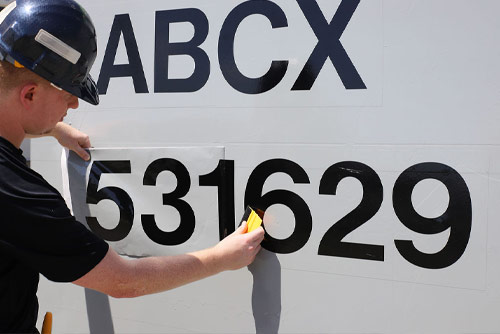 Man applying a rail decal