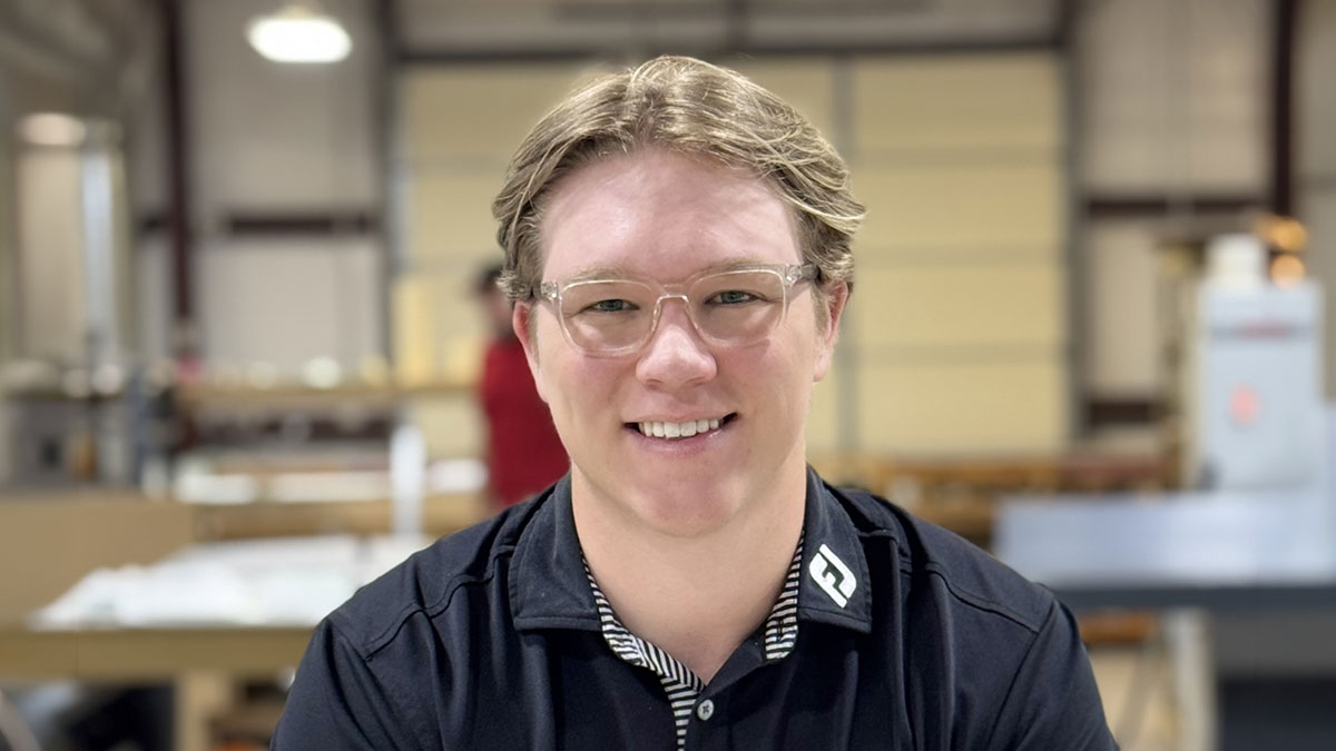 Photo of Carston Cox in warehouse at Trans Tech.